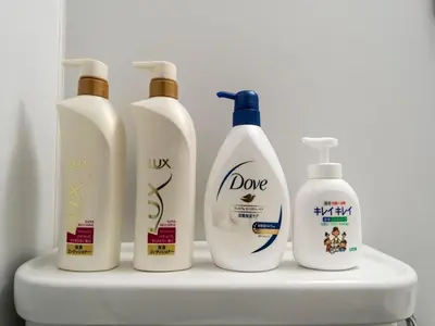 a group of four bottles of detergent on a shelf at Maison de Takinogawa - Vacation STAY 16165 in Tokyo