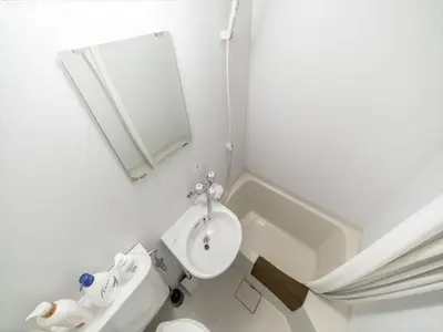 a bathroom with a sink and a toilet and a mirror at Maison de Takinogawa - Vacation STAY 16165 in Tokyo