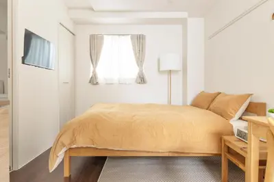 a bedroom with a bed and a window at Float Inn Asakusa in Tokyo