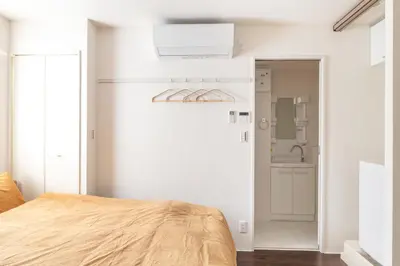 a bedroom with a bed and a sink at Float Inn Asakusa in Tokyo