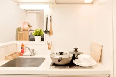 a kitchen counter with a sink and a pot and dishes at Mi-Ochiai Soluna White in Tokyo