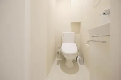 a white bathroom with a toilet in a stall at EveryNet ShinjukuⅡ in Tokyo