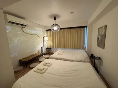 a bedroom with two beds and a lamp at waseda house in Tokyo