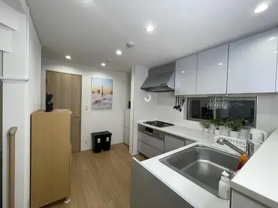 a kitchen with white cabinets and a kitchen sink at Bisk Park Higashijujo - Vacation STAY 83637v in Tokyo