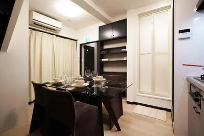 a dining room with a black table and chairs at Penthouse 1-bedroom flat in Hiroo Shibuya in Tokyo