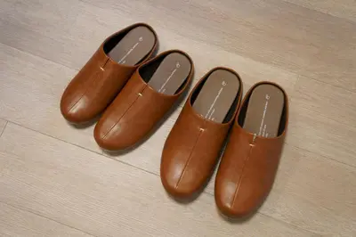 three pairs of brown boots sitting on a wooden floor at Penthouse 1-bedroom flat in Hiroo Shibuya in Tokyo
