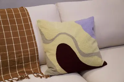 a couch with two pillows on it with at Penthouse 1-bedroom flat in Hiroo Shibuya in Tokyo
