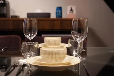 a table with plates and wine glasses on it at Penthouse 1-bedroom flat in Hiroo Shibuya in Tokyo