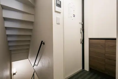 a hallway with a white door and a cabinet at THE CONTRAIL Ebisu in Tokyo