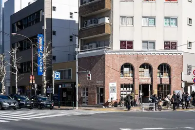 a busy city street with a brick building at THE CONTRAIL Ebisu in Tokyo