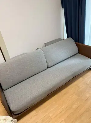 a couch sitting on the floor in a room at G&R House 202　Shinjuku room in Tokyo
