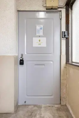 a white door in a building with a sign on it at G&R House 202　Shinjuku room in Tokyo