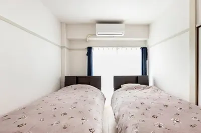 a small bedroom with a bed and a window at G&R House 202　Shinjuku room in Tokyo