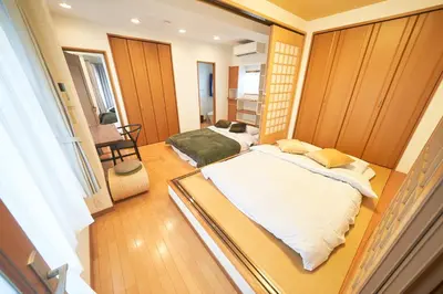 a small room with two beds in it at FINOA Ikebukuro Sky Terrace Suite in Tokyo