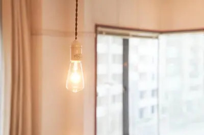a light bulb hanging in a room with a window at FINOA Ikebukuro Sky Terrace Suite in Tokyo