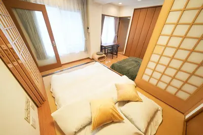 a large bed in a room with windows at FINOA Ikebukuro Sky Terrace Suite in Tokyo