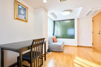 a living room with a table and a couch at L-Large 3Bedroom Luxury Condo, 140sqm Max 19 PPL, 7mins walk to station, Elevator,QuiteArea in Tokyo