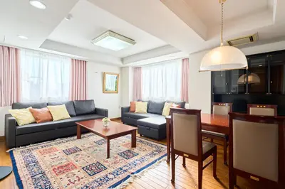 a living room with a couch and a table at L-Large 3Bedroom Luxury Condo, 140sqm Max 19 PPL, 7mins walk to station, Elevator,QuiteArea in Tokyo
