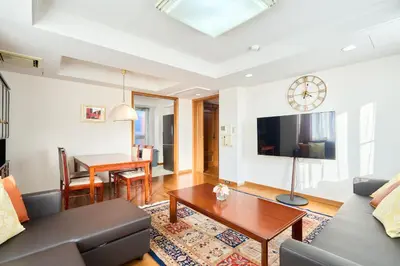 a living room with a couch and a table at L-Large 3Bedroom Luxury Condo, 140sqm Max 19 PPL, 7mins walk to station, Elevator,QuiteArea in Tokyo