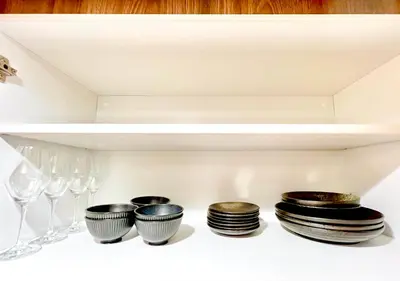 a shelf with plates and wine glasses on it at East Ikebukuro Living&Bed Sunshine City in Tokyo