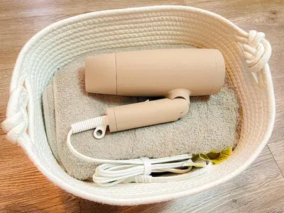 a wicker basket with a phone and cables in it at East Ikebukuro Living&Bed Sunshine City in Tokyo