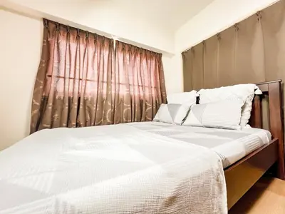 a bedroom with a large white bed with a window at East Ikebukuro Living&Bed Sunshine City in Tokyo