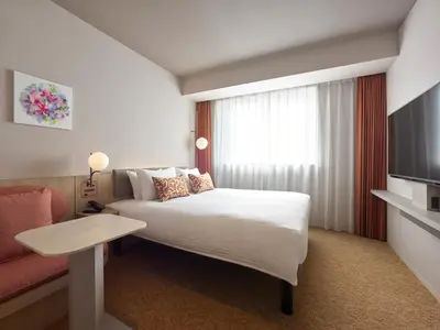 a hotel room with a bed and a television at Mitsui Garden Hotel Ginza Tsukiji in Tokyo