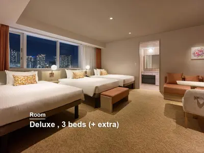 a hotel room with two beds and a couch at Mitsui Garden Hotel Ginza Tsukiji in Tokyo