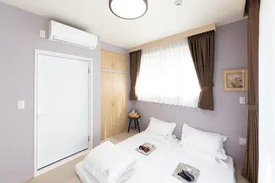 a bedroom with a bed with white sheets and a window at Light Hotel - Vacation STAY 91012v in Tokyo