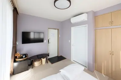 a bedroom with a bed and a tv on the wall at Light Hotel - Vacation STAY 91012v in Tokyo