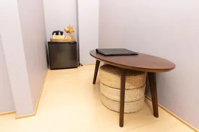 a table with a laptop on top of a stool at Light Hotel - Vacation STAY 91078v in Tokyo
