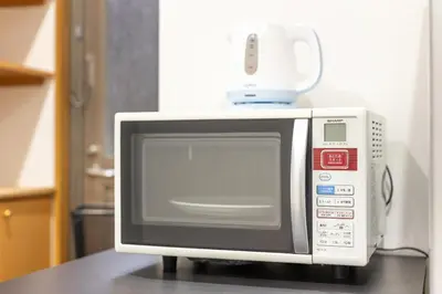 a microwave sitting on top of a counter at A Marvelous Blend of Tradition and Modernity, Independent 1st-floor Suite, Accommodates Up to 10 Guests! in Tokyo