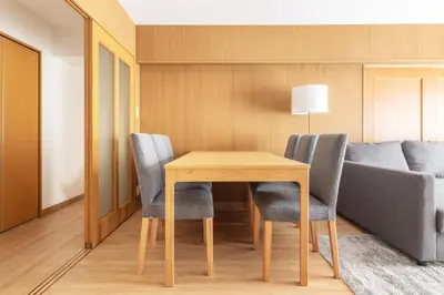 a table and chairs in a room with a couch at A Marvelous Blend of Tradition and Modernity, Independent 1st-floor Suite, Accommodates Up to 10 Guests! in Tokyo