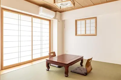 a table in a room with a large window at A Marvelous Blend of Tradition and Modernity, Independent 1st-floor Suite, Accommodates Up to 10 Guests! in Tokyo
