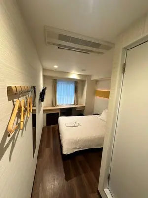 a small room with a bed and a window at ELE Hotel \u6771\u65e5\u672c\u6a4b in Tokyo