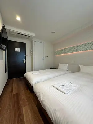 two beds sitting next to each other in a room at ELE Hotel \u6771\u65e5\u672c\u6a4b in Tokyo