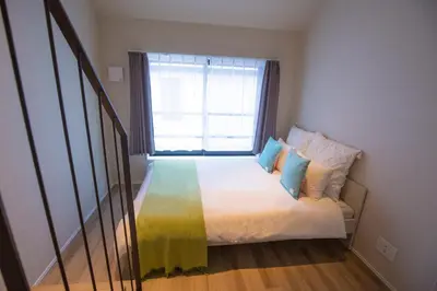 a small bedroom with a bed with a window at The most comfortable and best choice for accommodation in Yoyogi SoSI in Tokyo