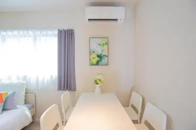 a white dining room with a white table and chairs at The most comfortable and best choice for accommodation in Yoyogi SoSI in Tokyo