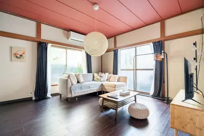 a living room with a couch and a tv at \u30a2\u30f3\u30c9\u30b9\u30c6\u30a4\u897f\u5c0f\u5ca91\u4e01\u76ee in Tokyo