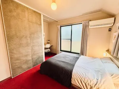 a bedroom with a large bed and a large window at lobby, tateishi - Sauna & Stay in Tokyo