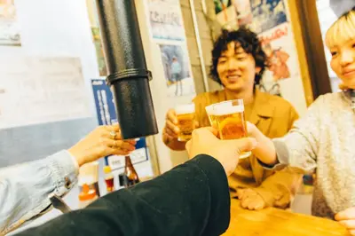 a group of people holding up glasses of beer at lobby, tateishi - Sauna & Stay in Tokyo
