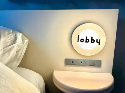 a bathroom with a toilet and a sign that reads lobbey at lobby, tateishi - Sauna & Stay in Tokyo