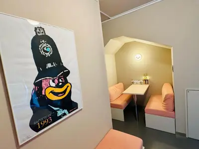 a room with a painting on the wall next to a bedroom at lobby, tateishi - Sauna & Stay in Tokyo