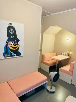 a small room with two beds and a table at lobby, tateishi - Sauna & Stay in Tokyo