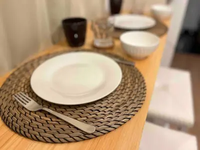 a wooden table with plates and utensils on it at \u30a2\u30f3\u30c9\u30b9\u30c6\u30a4\u6c60\u888b4\u4e01\u76ee502 in Tokyo