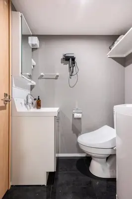 a bathroom with a white toilet and a sink at \u30a2\u30f3\u30c9\u30b9\u30c6\u30a4\u6c60\u888b4\u4e01\u76ee502 in Tokyo