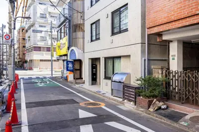 an empty city street with orange cones and buildings at \u30a2\u30f3\u30c9\u30b9\u30c6\u30a4\u6c60\u888b4\u4e01\u76ee502 in Tokyo