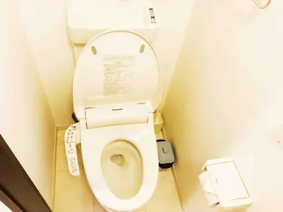 a small bathroom with a toilet with the lid up at \u30a2\u30f3\u30c9\u30b9\u30c6\u30a4\u5cf6\u5c3b5\u4e01\u76ee in Tokyo