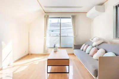 a living room with a couch and a table at \u30a2\u30f3\u30c9\u30b9\u30c6\u30a4\u5357\u9577\u5d0e5\u4e01\u76ee in Tokyo