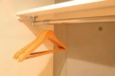 a wooden hanger is hanging on a wall at Tokyo Time Traveler \u99c5\u5f92\u6b695\u5206 \u66ae\u3089\u3059\u3088\u3046\u306b\u6cca\u307e\u308c\u308b\u30db\u30c6\u30eb in Tokyo